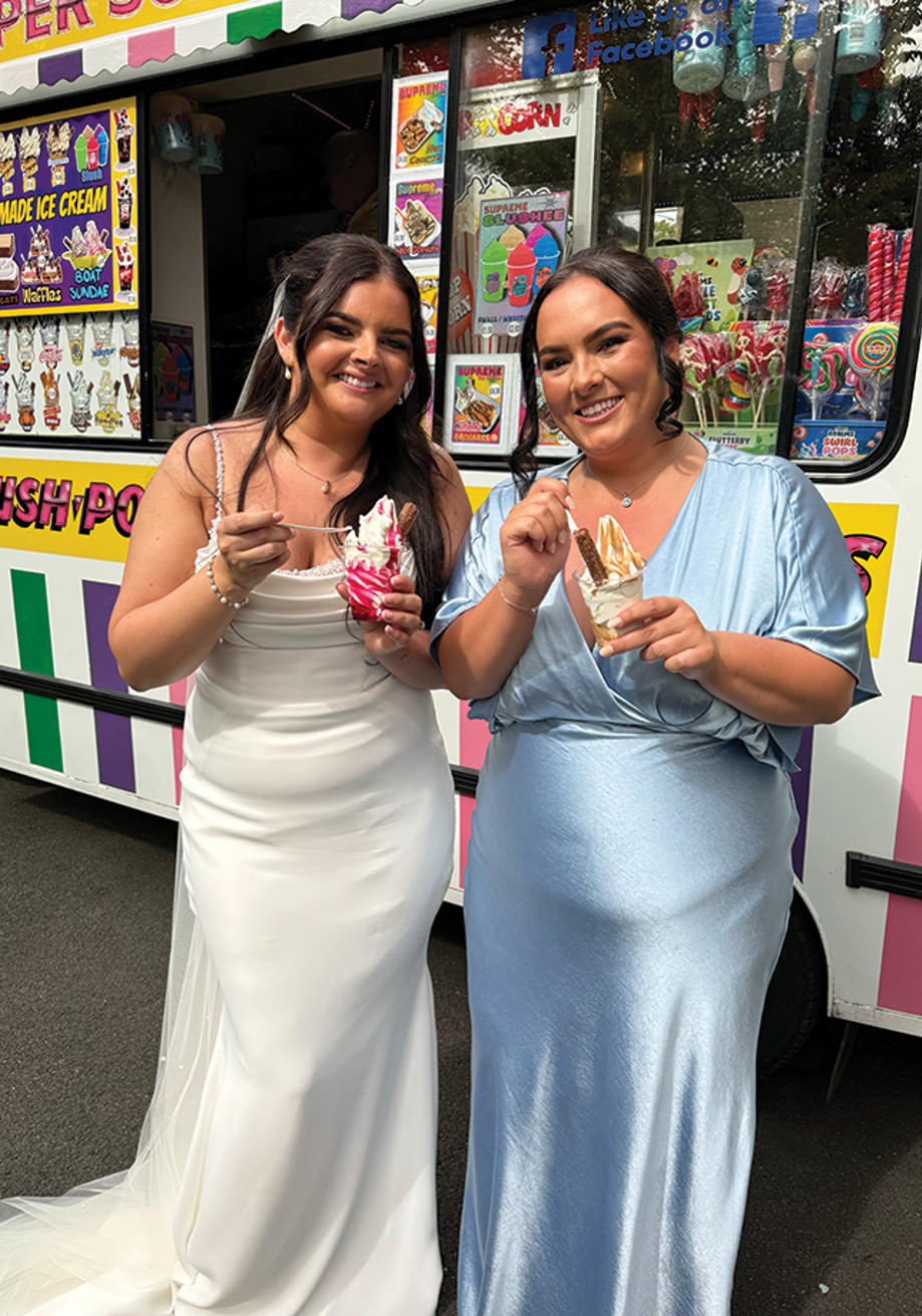 Bride and her bridesmaid enjoy ice cream in front of ice cream van